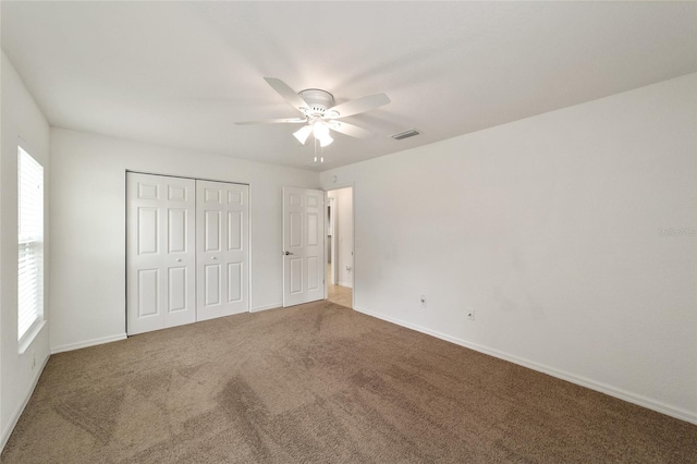 unfurnished bedroom with ceiling fan and carpet