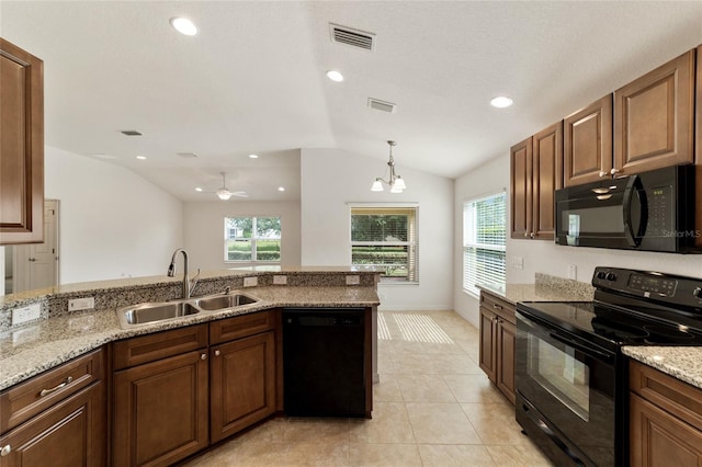 kitchen with black appliances, ceiling fan with notable chandelier, sink, vaulted ceiling, and light stone counters