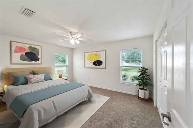 carpeted bedroom with a closet and ceiling fan