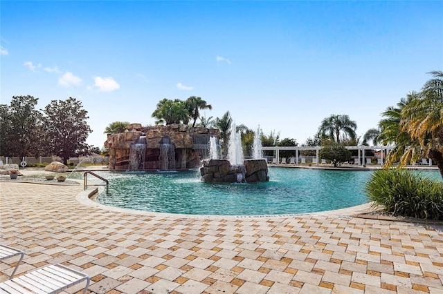 view of swimming pool with pool water feature