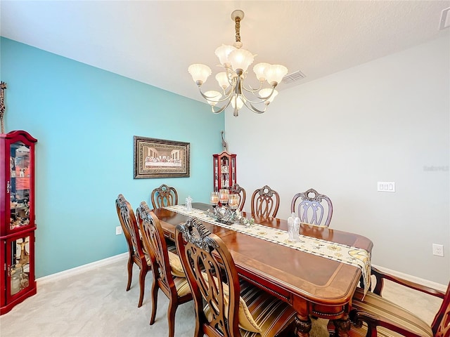 dining room featuring carpet flooring and an inviting chandelier