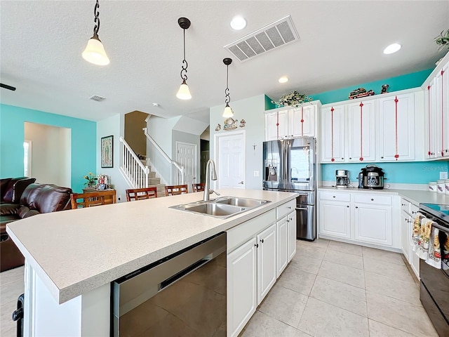 kitchen featuring appliances with stainless steel finishes, sink, an island with sink, and pendant lighting