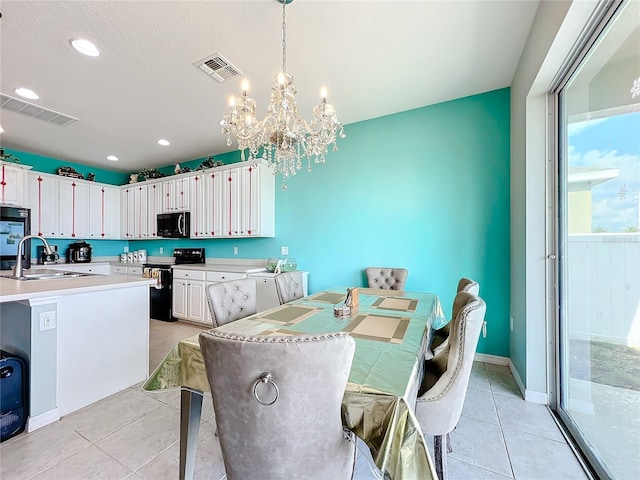 tiled dining area with sink and an inviting chandelier