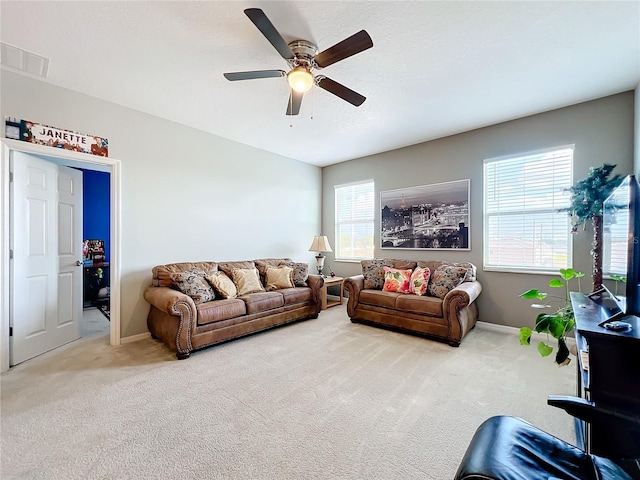 carpeted living room featuring ceiling fan