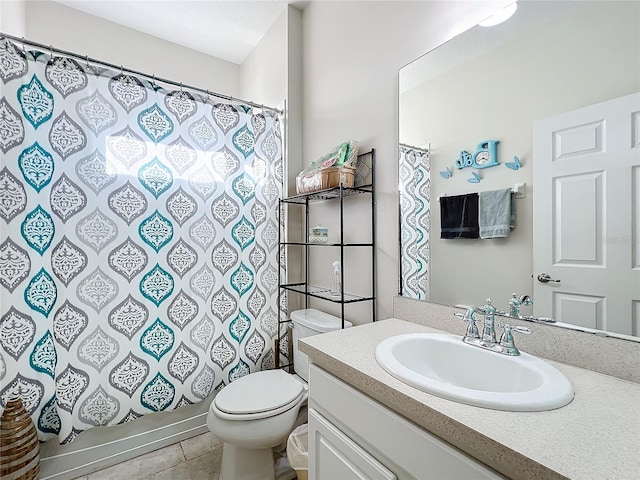 bathroom featuring tile flooring, toilet, and large vanity