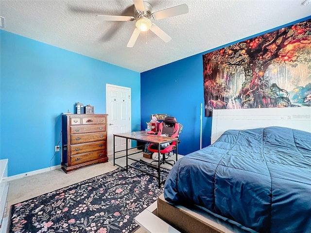 bedroom featuring carpet, ceiling fan, and a textured ceiling