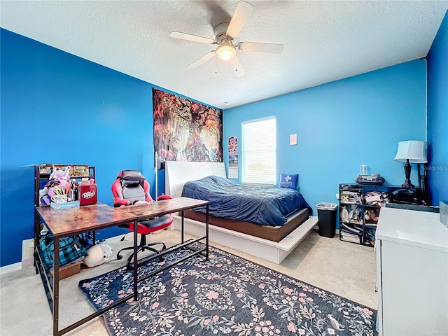 carpeted bedroom with a textured ceiling and ceiling fan