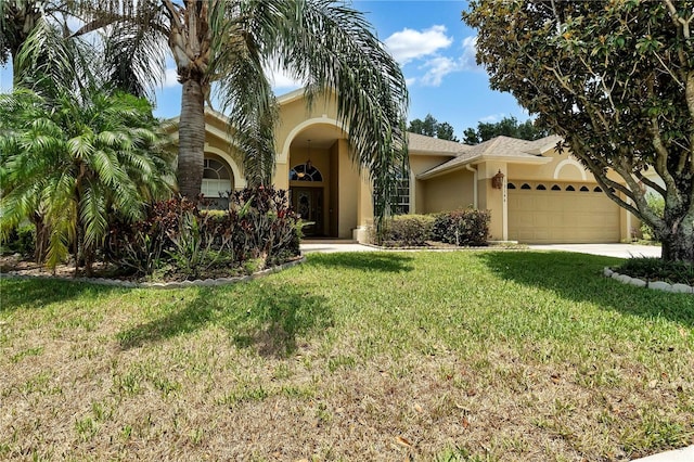 view of front of home featuring a front lawn and a garage