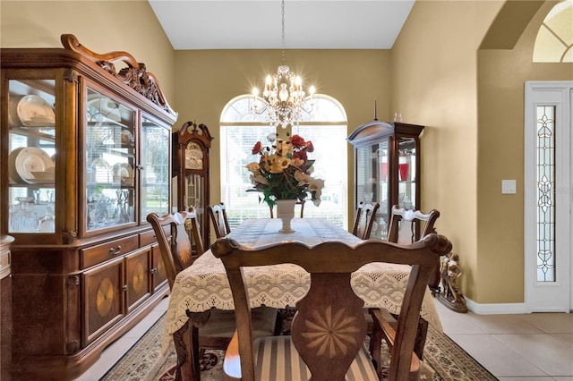 dining space featuring light tile patterned floors and an inviting chandelier