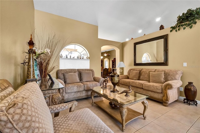 tiled living room with ceiling fan