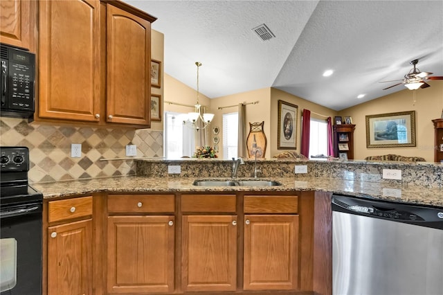 kitchen with light stone counters, sink, black appliances, and lofted ceiling