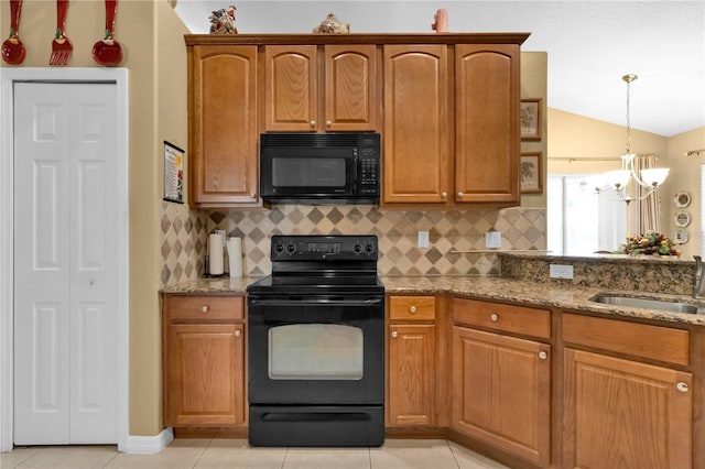 kitchen with light stone countertops, sink, black appliances, a chandelier, and lofted ceiling