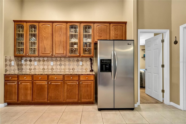 kitchen with stainless steel fridge and light tile patterned floors