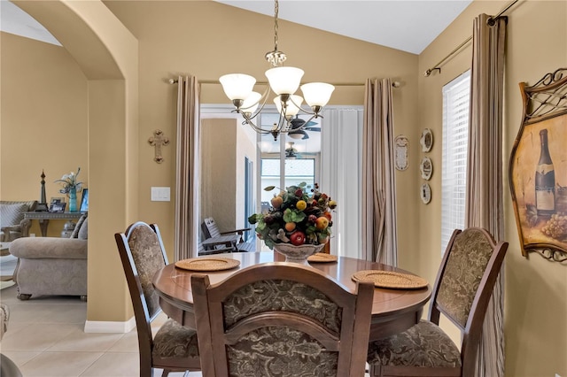 dining space featuring light tile patterned floors, a chandelier, and lofted ceiling