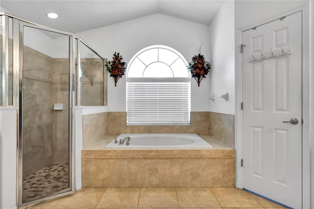 bathroom with tile patterned flooring, independent shower and bath, and lofted ceiling