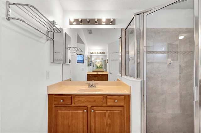 bathroom with vanity and a shower with shower door