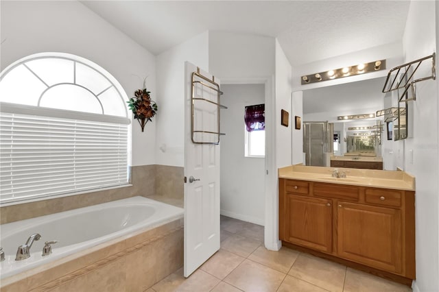 bathroom featuring vanity, tile patterned floors, and separate shower and tub