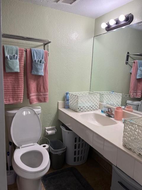 bathroom featuring toilet and sink