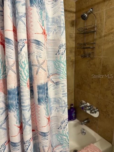 bathroom with shower / bathtub combination with curtain