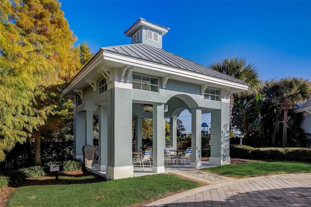 exterior space featuring a patio area and a lawn