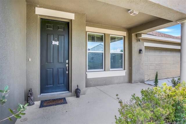 doorway to property with a garage