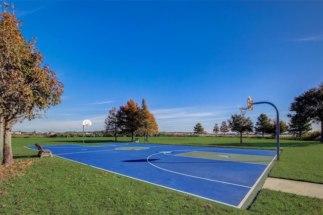 view of sport court featuring a lawn