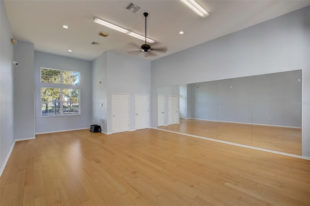 unfurnished living room featuring ceiling fan and light hardwood / wood-style floors