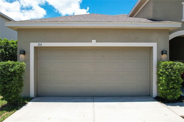 garage featuring concrete driveway