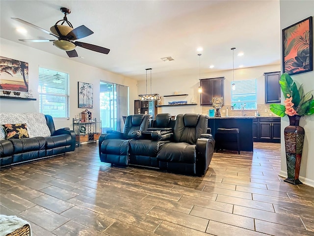 living room featuring ceiling fan, wood finish floors, and visible vents