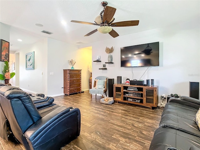 living room featuring ceiling fan, wood finished floors, visible vents, and baseboards