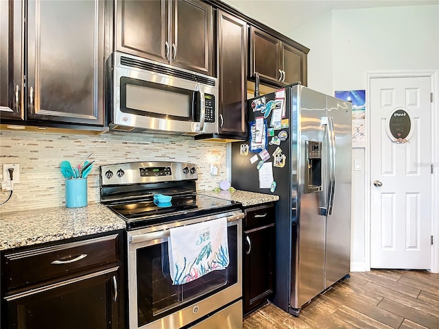 kitchen featuring hardwood / wood-style flooring, light stone countertops, appliances with stainless steel finishes, and dark brown cabinets