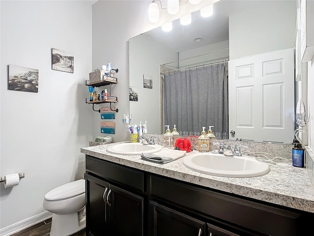 bathroom featuring hardwood / wood-style flooring, vanity, toilet, and walk in shower