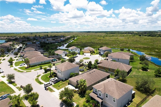 birds eye view of property with a water view and a residential view