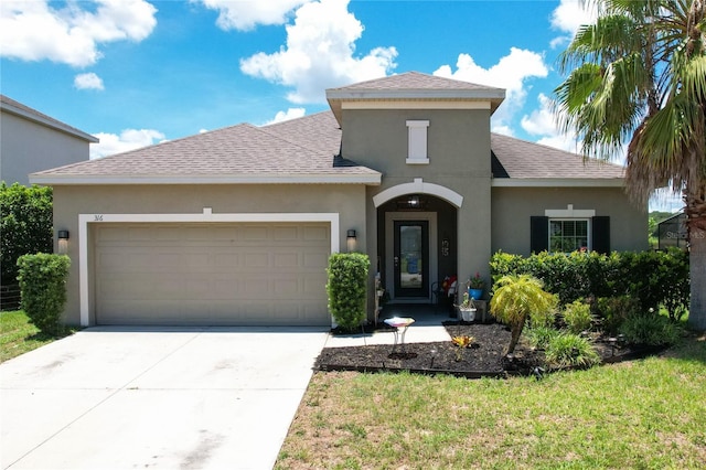 view of front of home featuring a garage and a front lawn