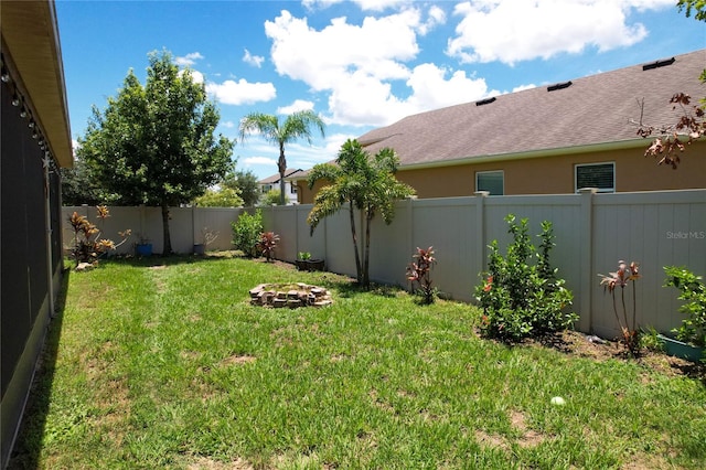 view of yard with a fire pit