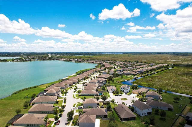 drone / aerial view featuring a residential view and a water view