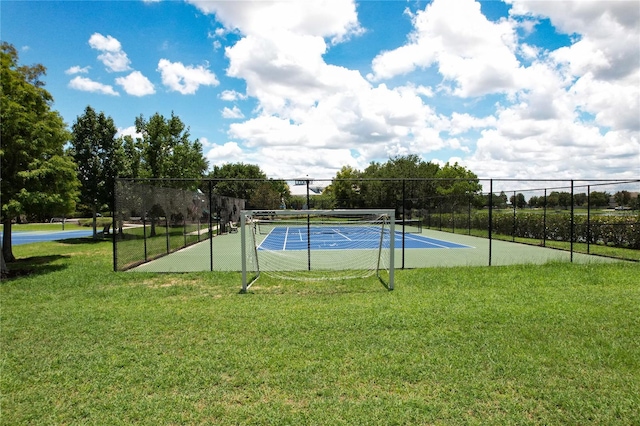 view of sport court featuring a lawn