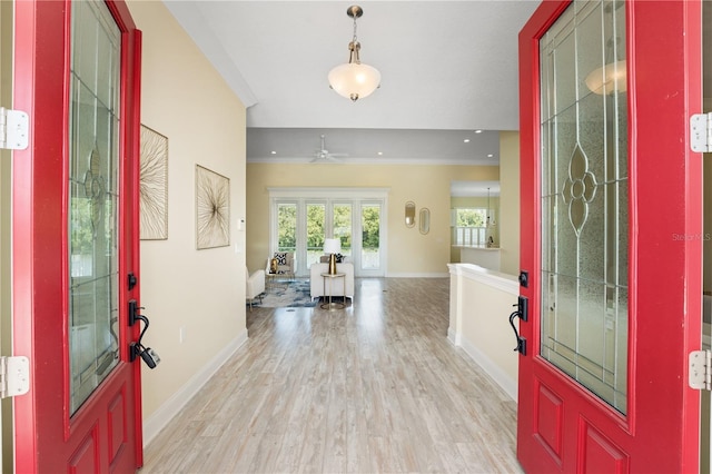 foyer with ceiling fan, light hardwood / wood-style floors, and french doors