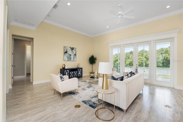 living room with crown molding, french doors, and light wood-type flooring