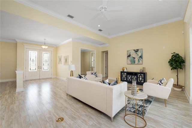 living room with crown molding, french doors, ceiling fan, and light hardwood / wood-style flooring