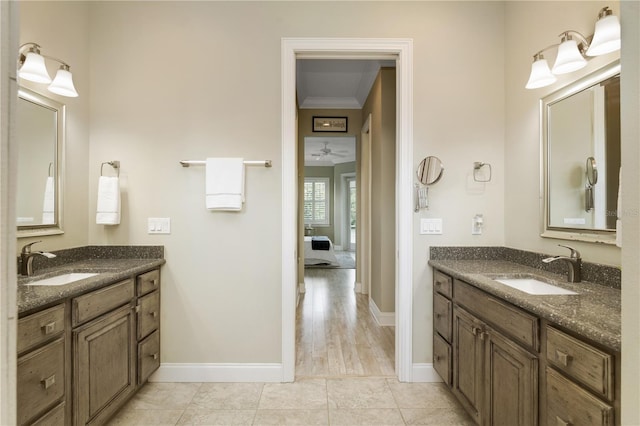 bathroom featuring tile patterned flooring, vanity, ceiling fan, and crown molding