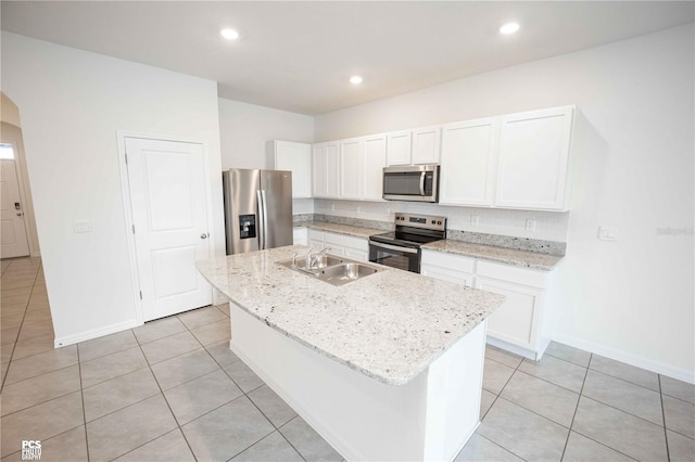 kitchen featuring sink, white cabinetry, a kitchen island with sink, and appliances with stainless steel finishes