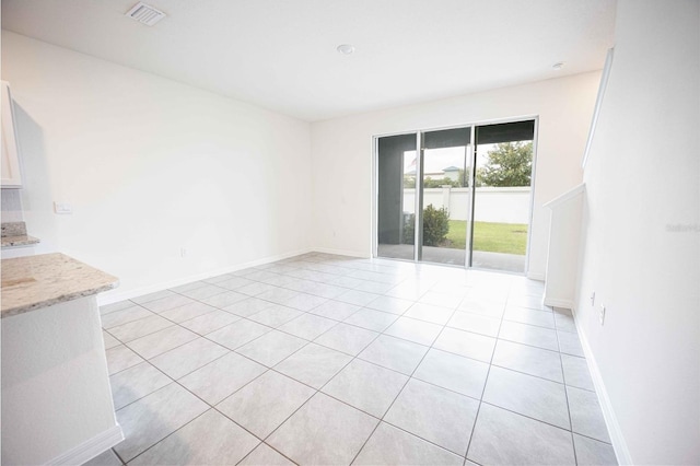 spare room featuring light tile patterned floors