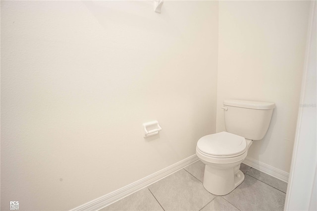 bathroom featuring tile patterned flooring and toilet