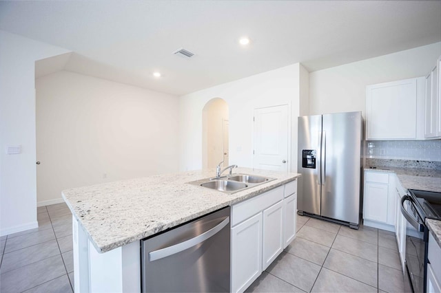 kitchen featuring white cabinets, sink, light tile patterned floors, an island with sink, and stainless steel appliances