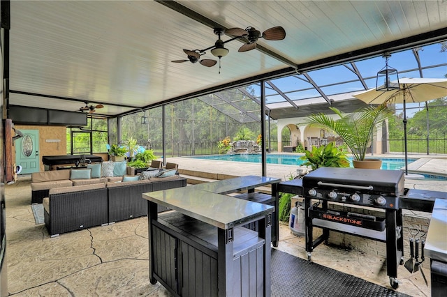 view of patio / terrace with an outdoor hangout area, ceiling fan, and a lanai