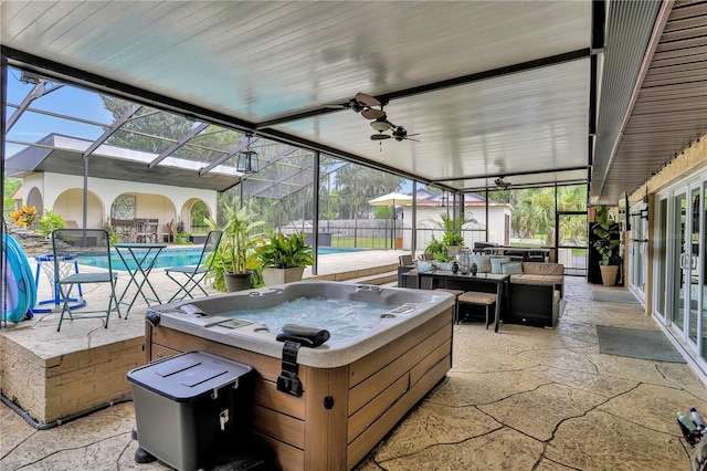 view of patio / terrace with glass enclosure, ceiling fan, a swimming pool with hot tub, and an outdoor hangout area