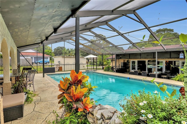 view of swimming pool featuring a patio area and a lanai