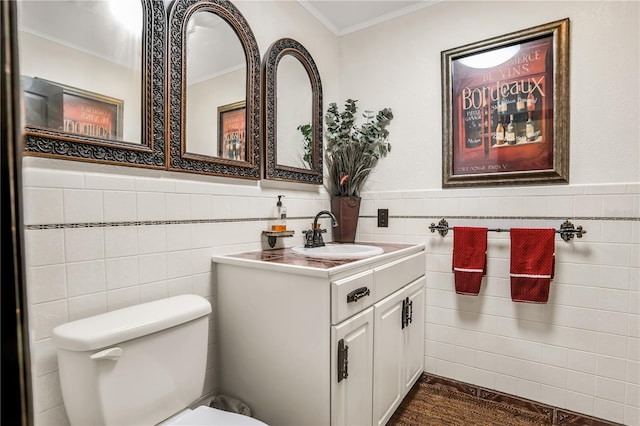 bathroom featuring vanity, crown molding, and tile walls