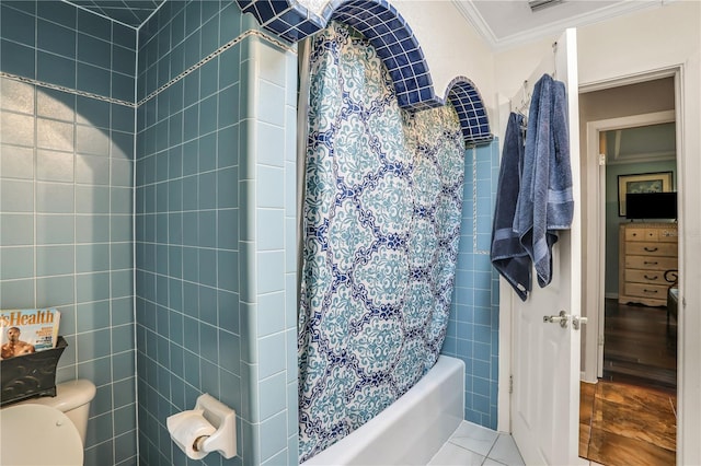 bathroom featuring tile patterned flooring, toilet, shower / bathtub combination with curtain, and crown molding